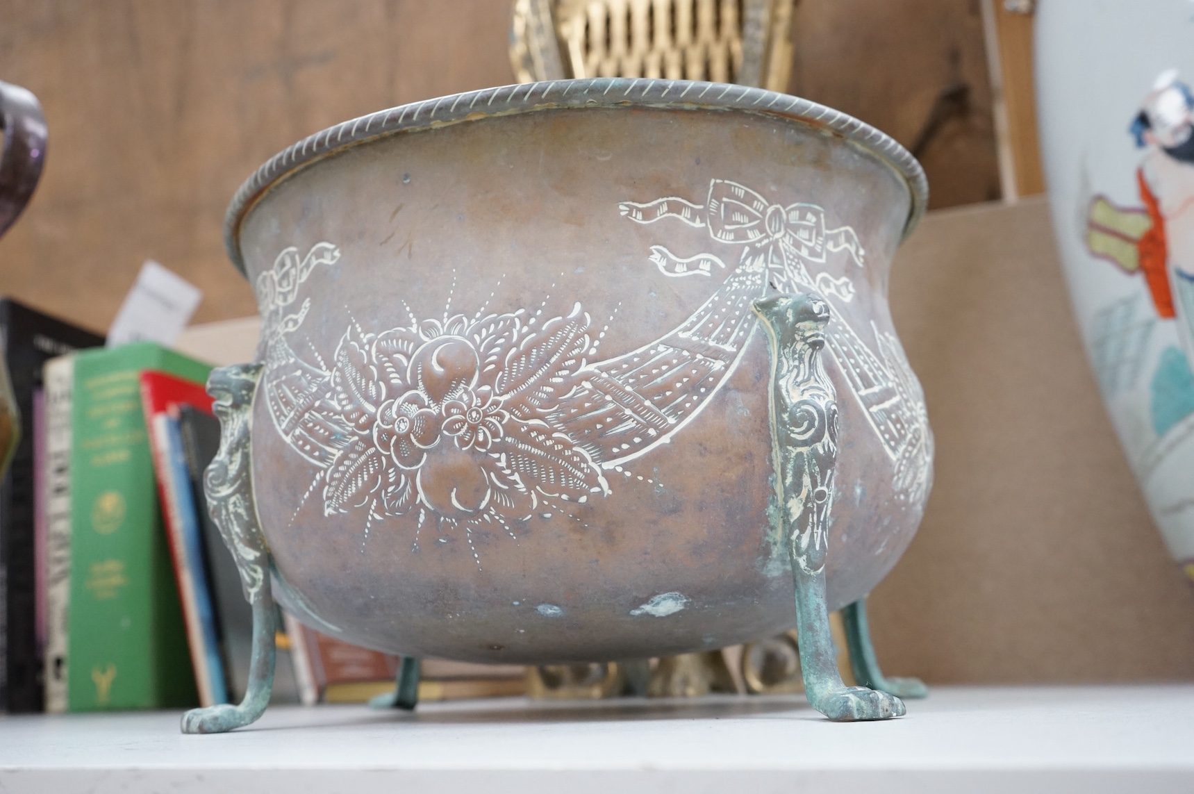 A brass fan shaped fireguard, a riveted jug and four footed planter. Fan shaped fire guard 63cm high. Condition - poor to fair